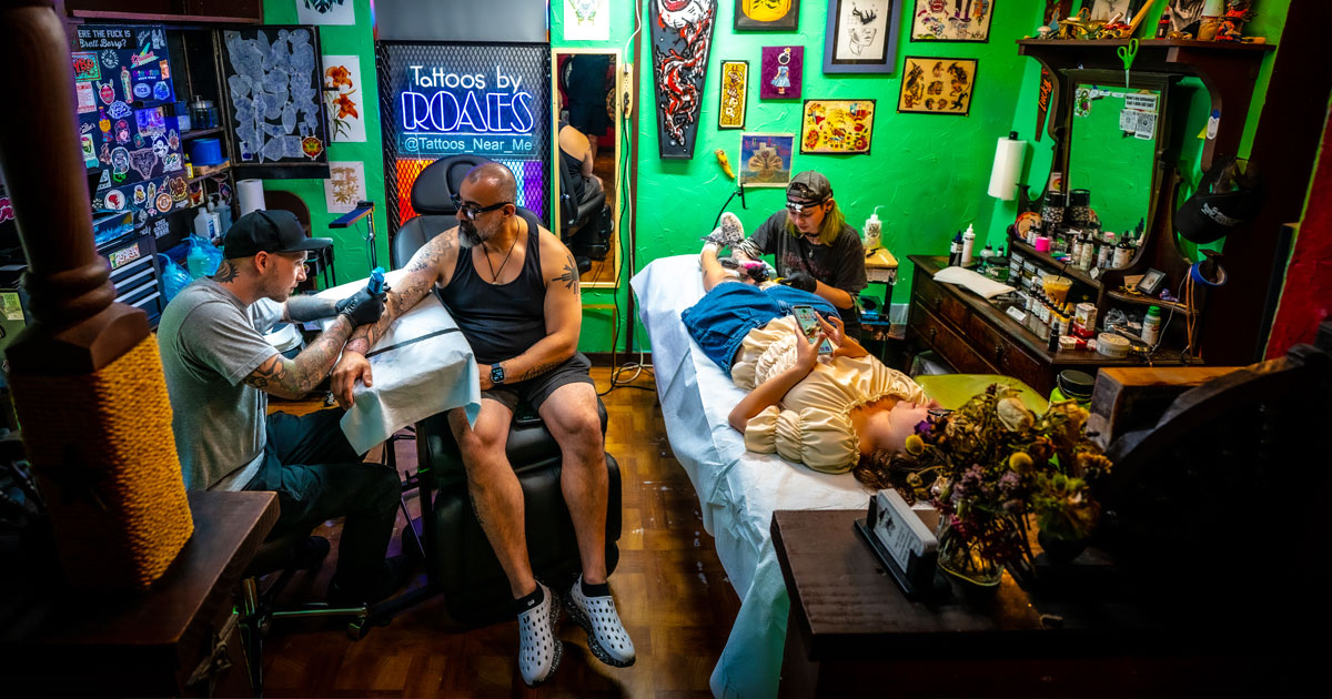 Travis at the shop finishing a sleeve a client.