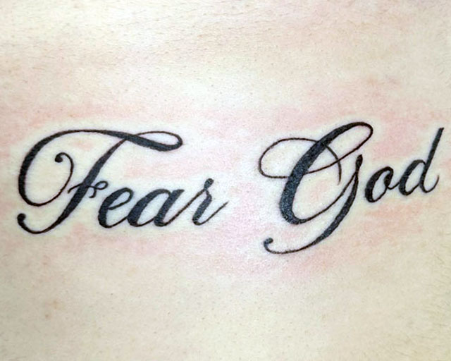 Lettering Font and Script Tattoo that says Fear God