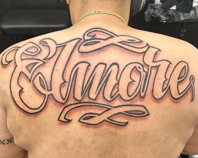 Lettering Font and Script Tattoo across the entire back that says ELINORE